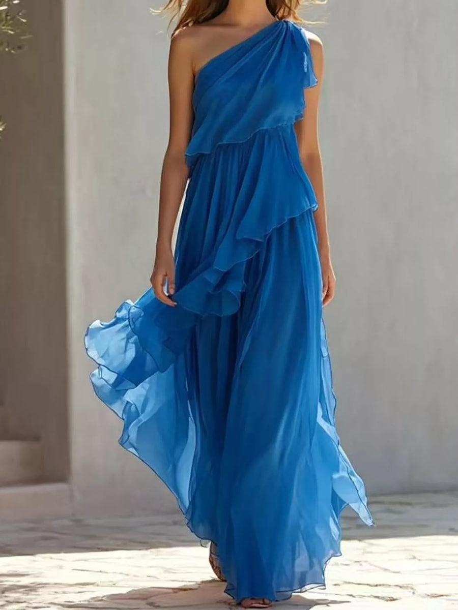 Model walking next to a white building wearing One-Shoulder Ruffled Chiffon Maxi Dress
