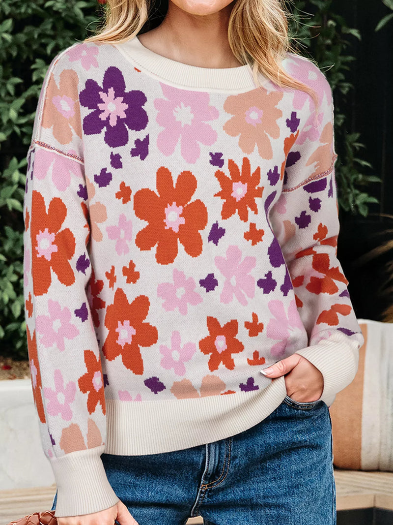 Person wearing a floral sweater with a blurred background