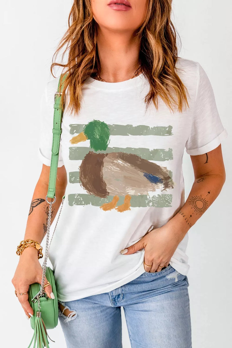 Person wearing a white t-shirt with a duck graphic, holding a green handbag.