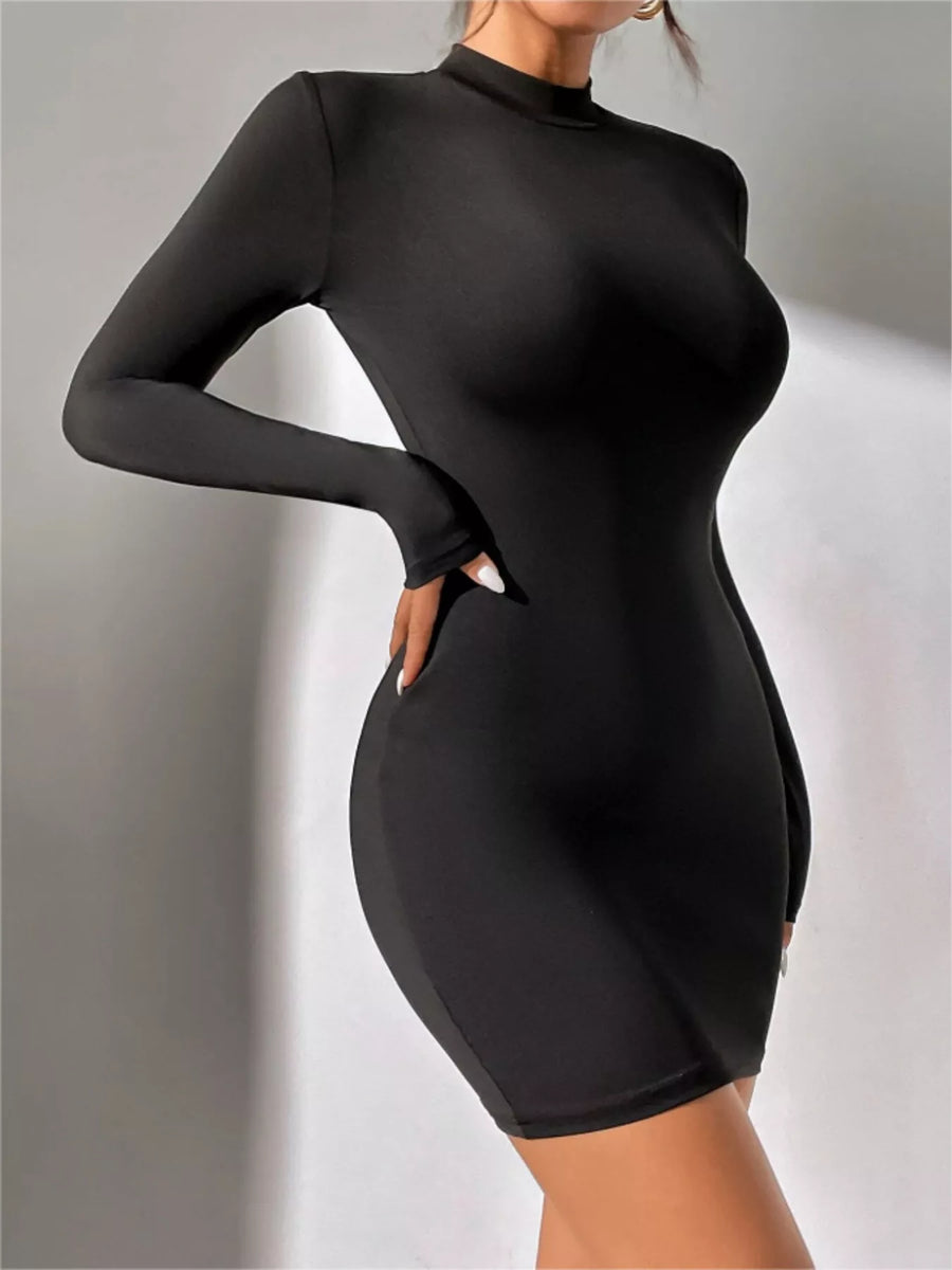 Black long-sleeve dress worn by a person on a gray background