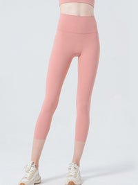 Pink leggings worn by a person on a light gray background