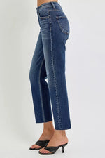 Blue jeans worn by a person on a light gray background