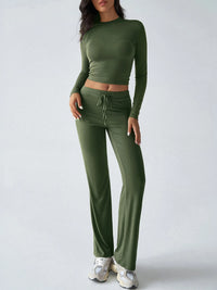 Green long-sleeve top and pants set on a white background