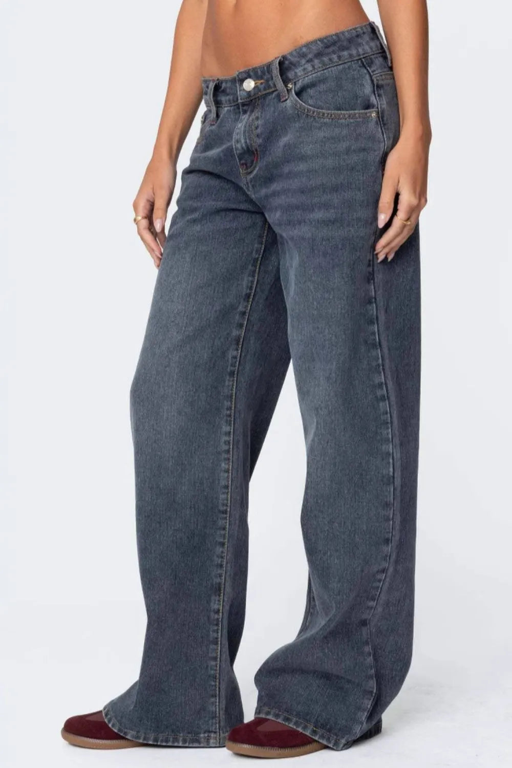 Blue jeans worn by a person on a white background