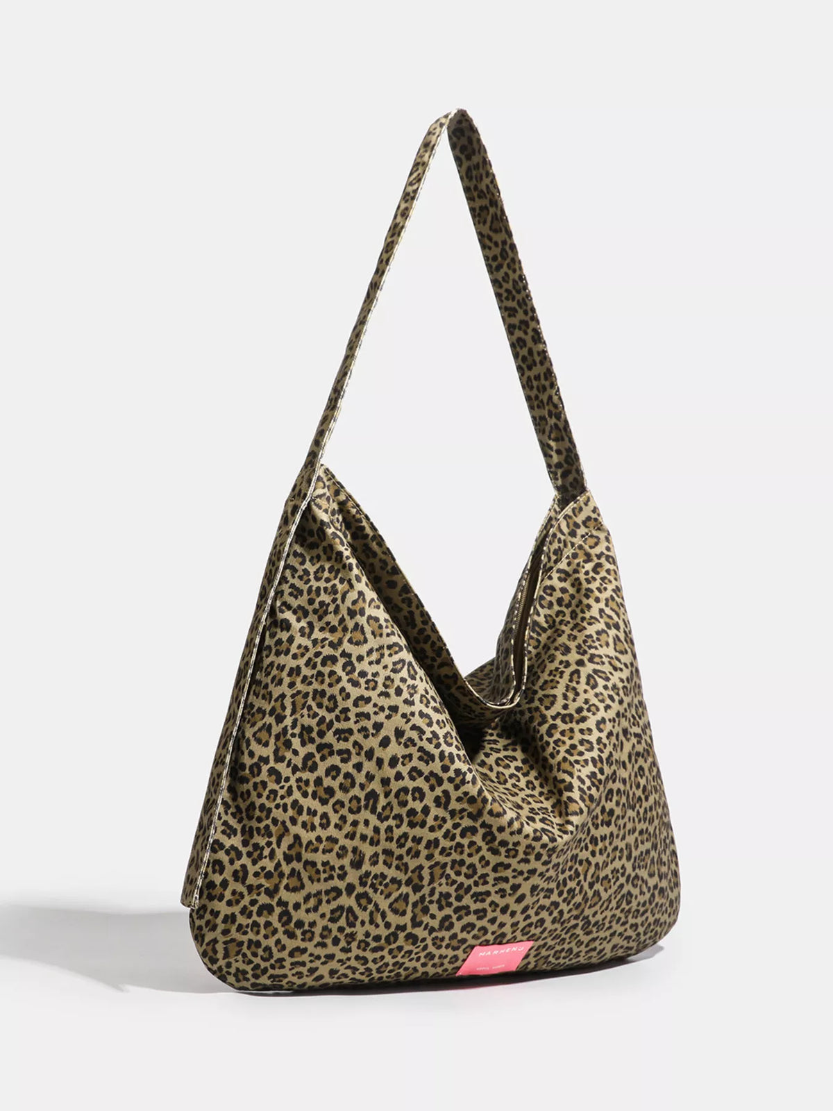 Leopard print handbag with a pink tag on a white background