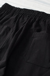 Close-up of black shorts with an elastic waistband on a white background