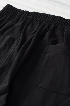 Close-up of black shorts with an elastic waistband on a white background