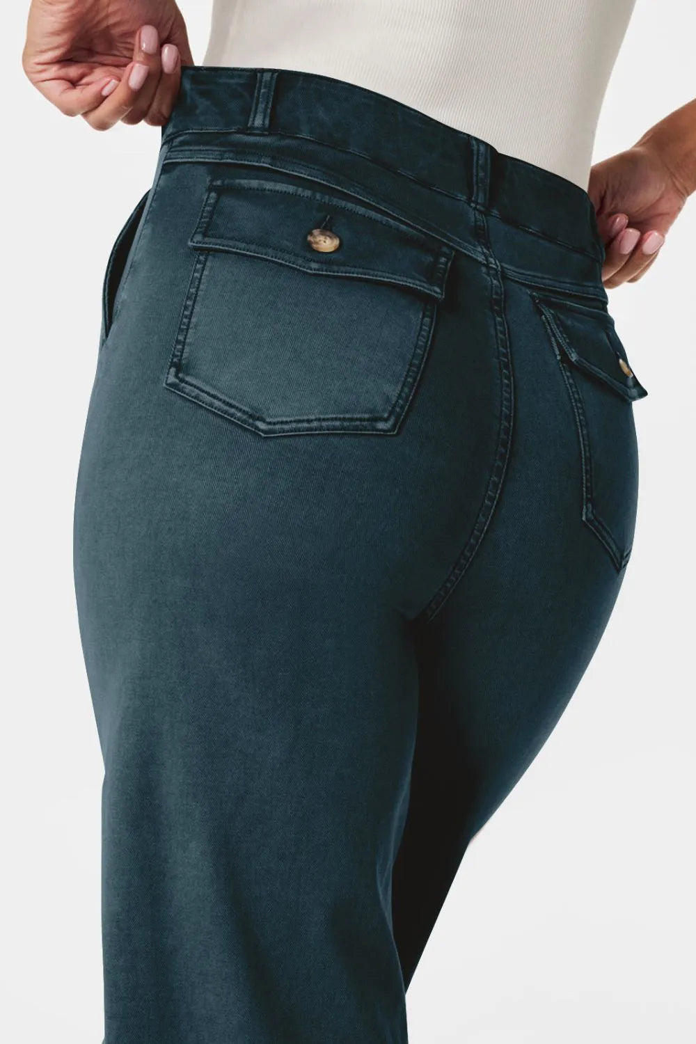 Teal jeans with a pocket detail on a white background