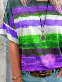 Person wearing a colorful striped shirt with a necklace and bracelet.