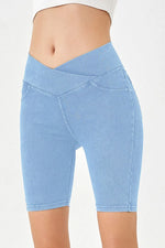 Light blue denim shorts on a white background
