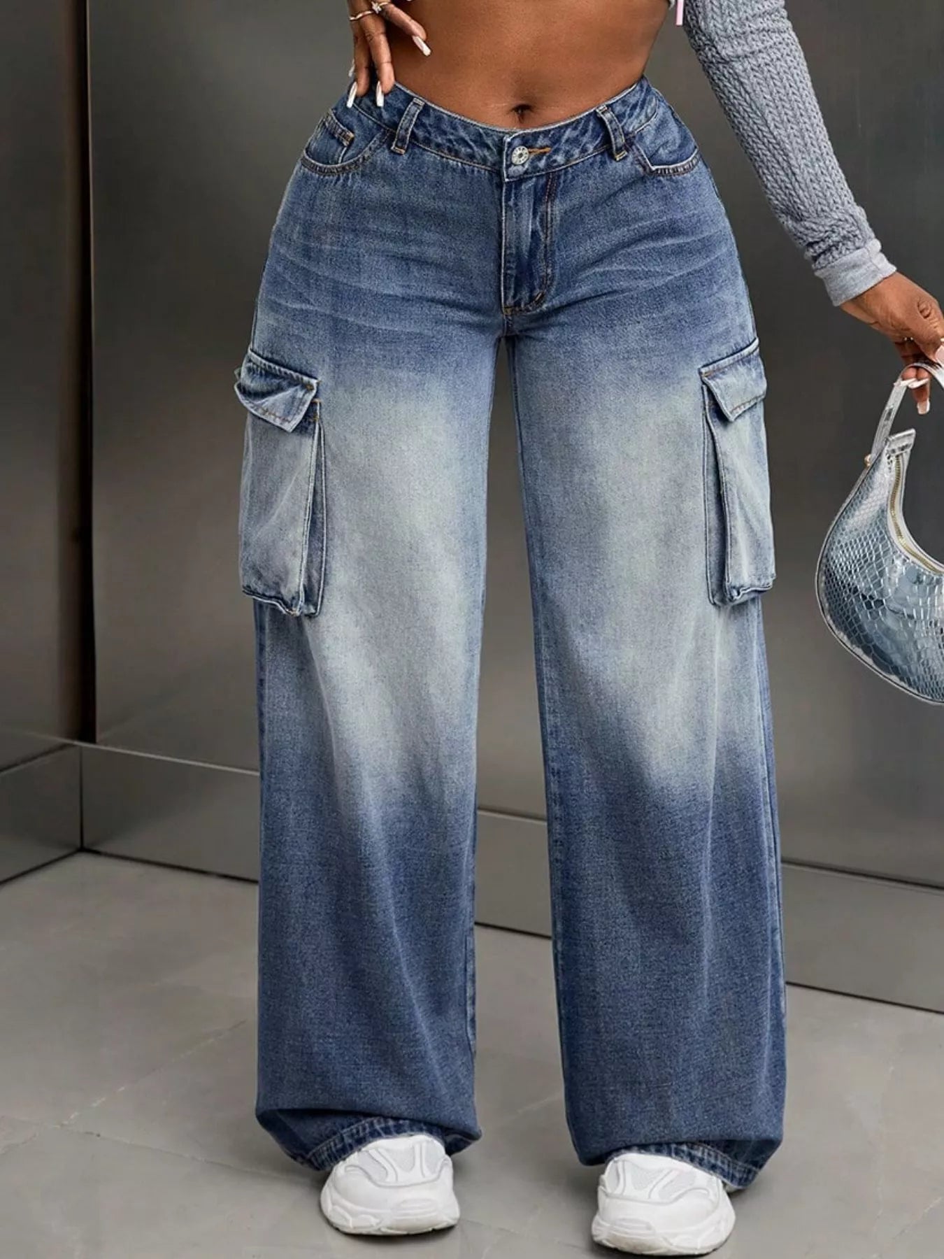 Person wearing blue gradient cargo pants with a blurred background