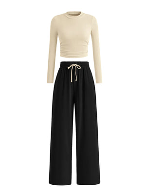 Beige long-sleeve top and black wide-leg pants on a white background