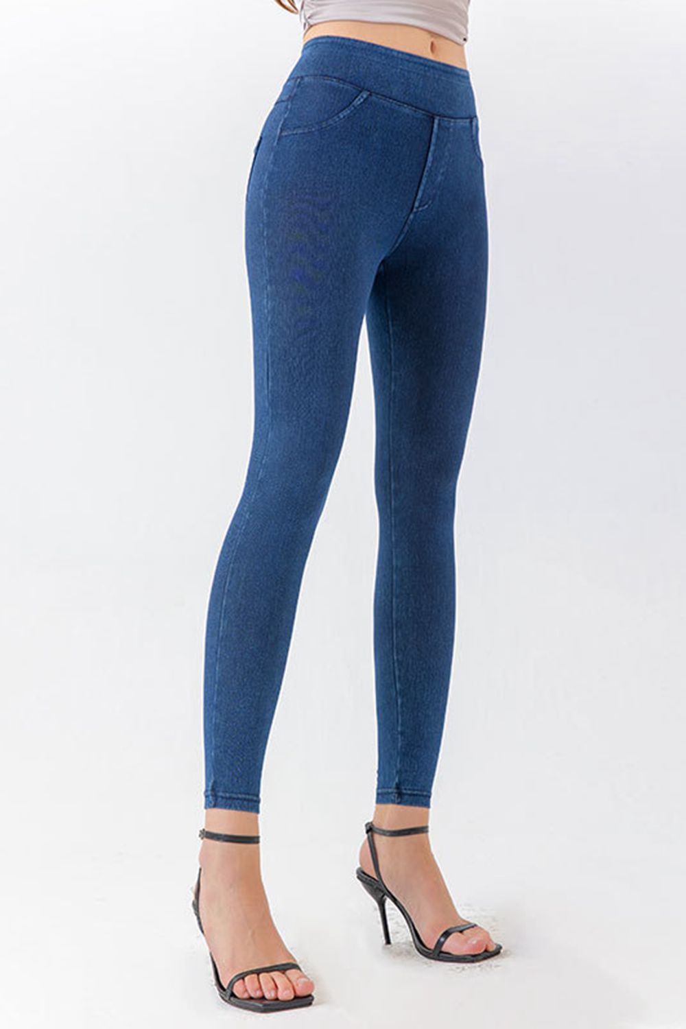 Blue leggings worn by a person on a white background