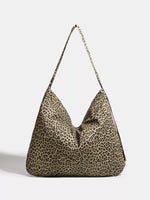 Leopard print handbag with a chain detail on a light gray background
