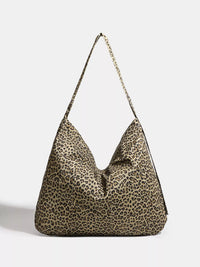 Leopard print handbag with a chain detail on a light gray background