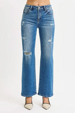 Blue distressed jeans on a white background