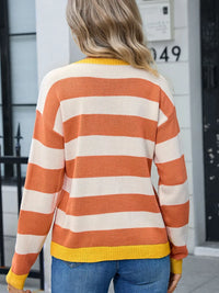 Woman showing back of orange and white sweater