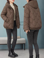 A woman modeling a brown quilted puffer jacket in two views: front and back. The jacket features a scalloped quilted pattern, a zippered front, and a hood.