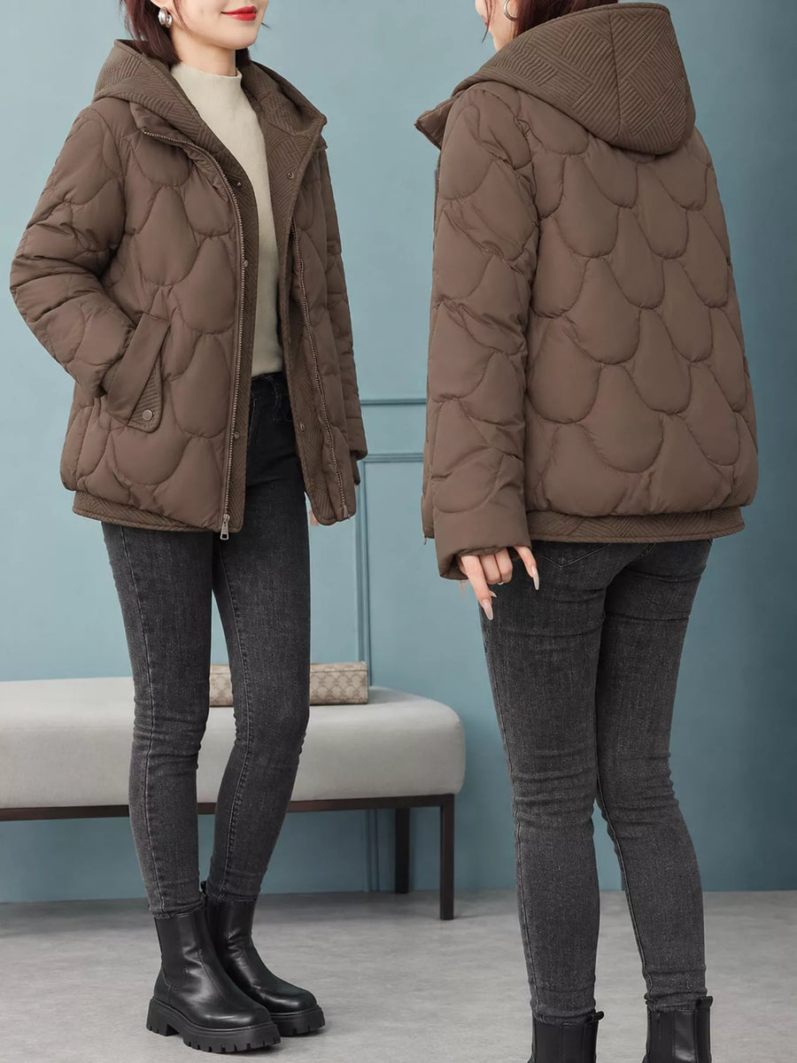 A woman modeling a brown quilted puffer jacket in two views: front and back. The jacket features a scalloped quilted pattern, a zippered front, and a hood.