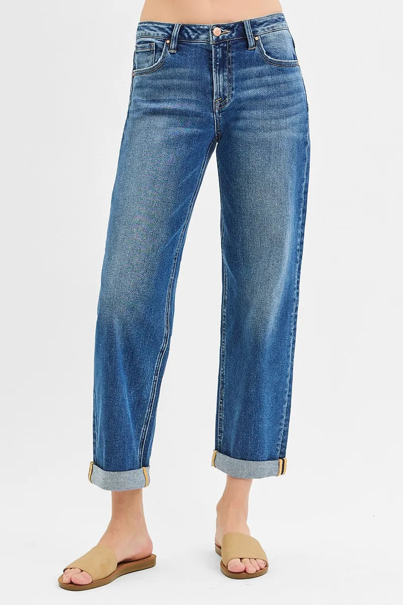 Blue jeans worn by a person on a light gray background