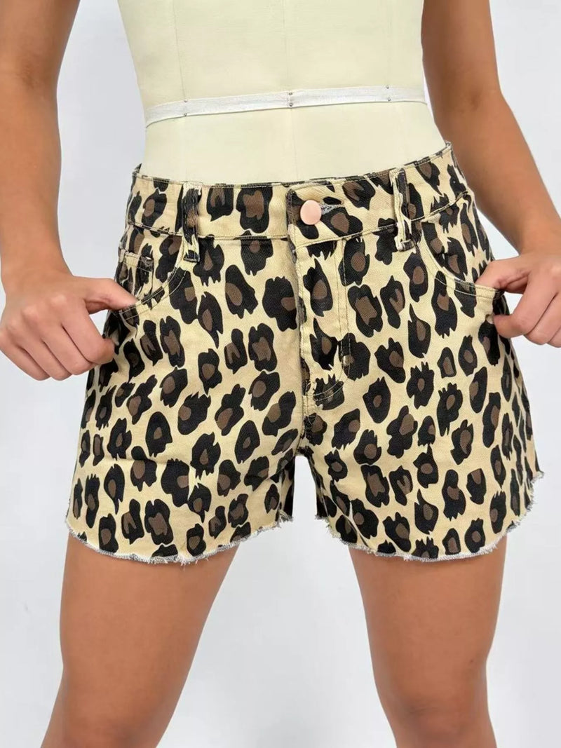 Leopard print shorts worn by a person on a plain background