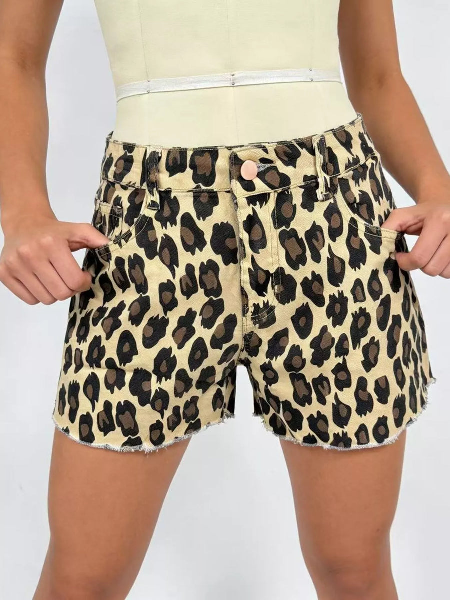 Leopard print shorts worn by a person on a plain background