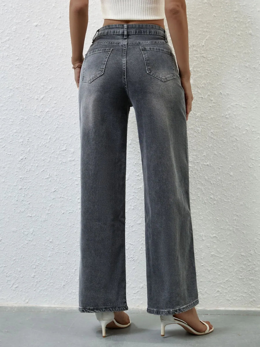 Person wearing wide-leg jeans against a plain background