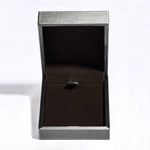 Black ring box with a silver rim on a white background