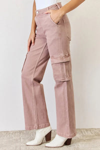 Pink cargo pants worn by a person on a plain background