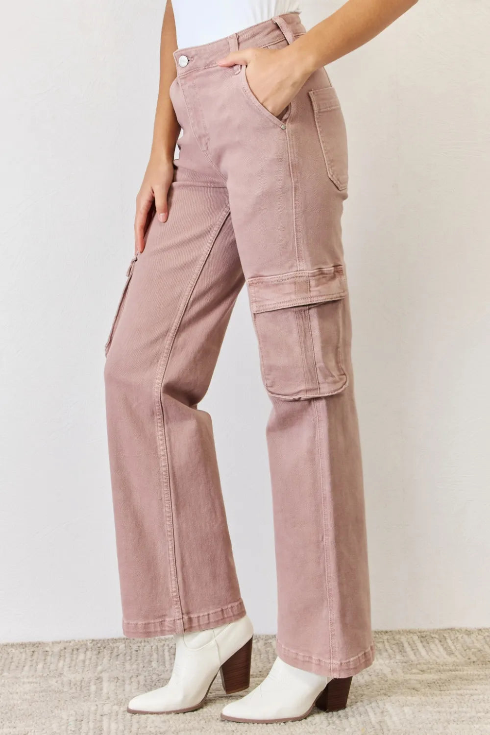 Pink cargo pants worn by a person on a plain background