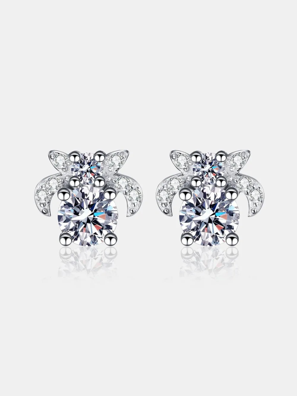 Turtle-shaped earrings with clear gemstones on a white background