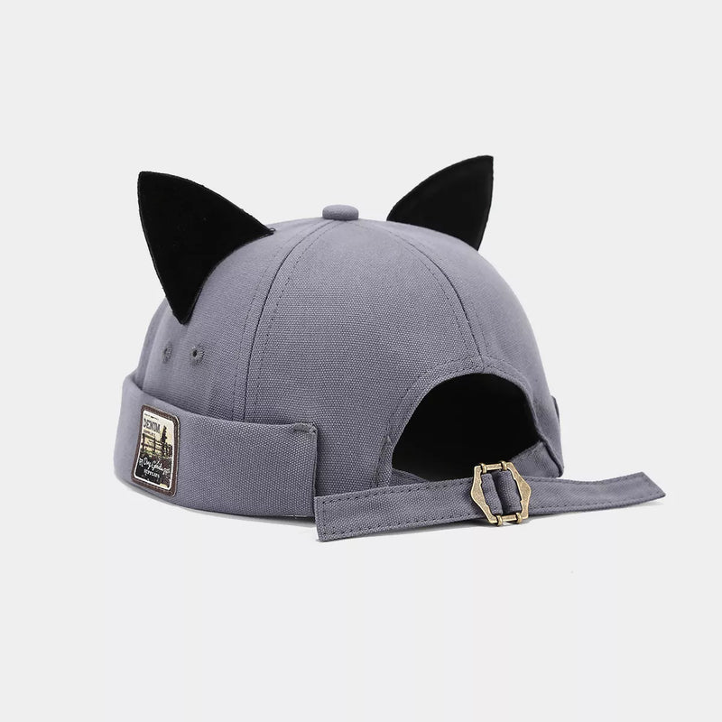 Gray cap with black cat ears on a light gray background