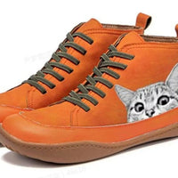 Orange sneakers with a cat design on a white background
