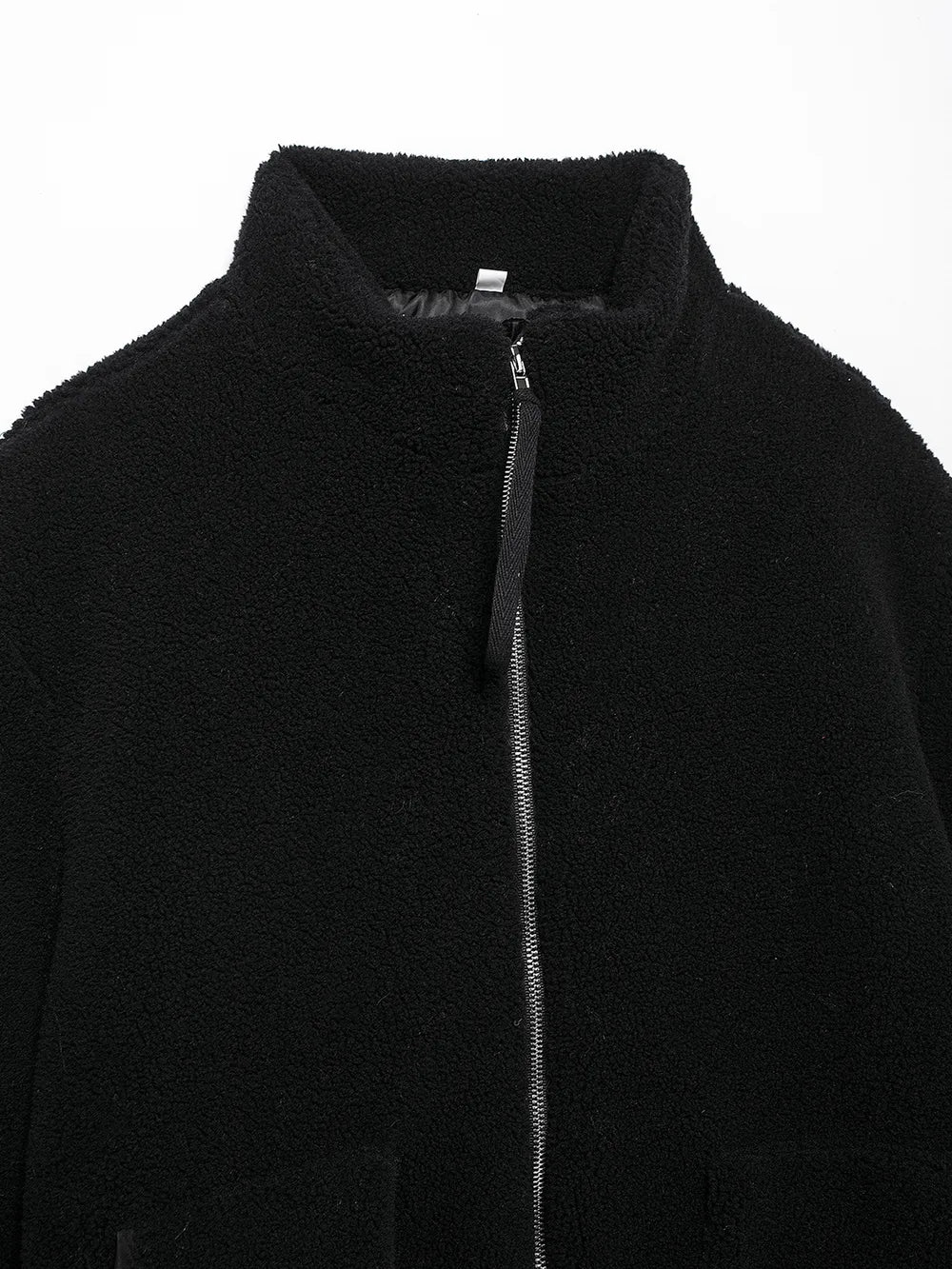 Close-up of a black jacket with a zipper on a white background