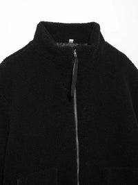 Close-up of a black jacket with a zipper on a white background