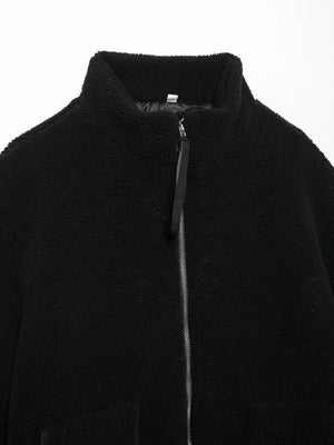 Close-up of a black jacket with a zipper on a white background