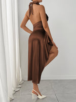 Woman wearing a brown dress with a white curtain and gray floor in the background