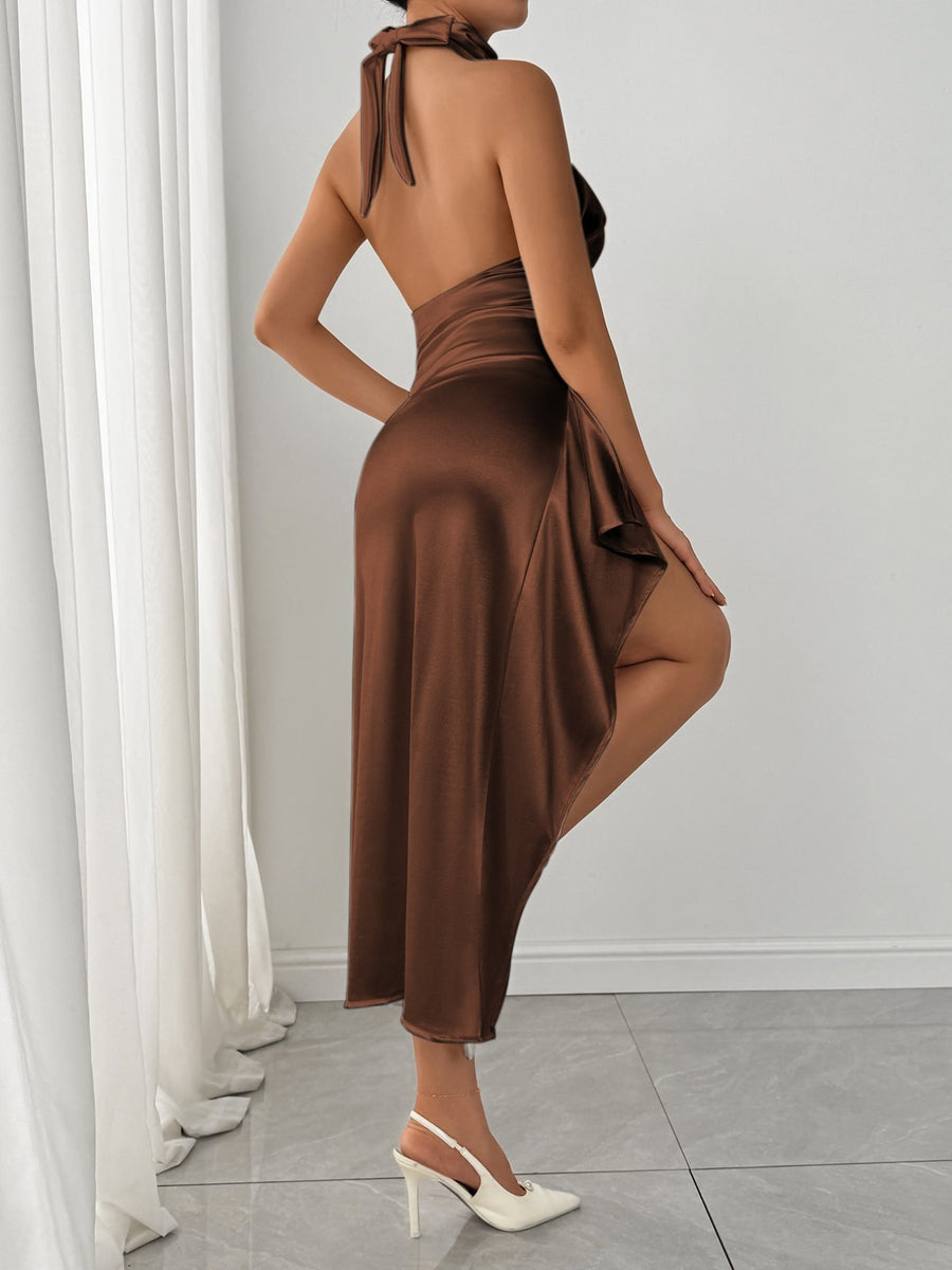 Woman wearing a brown dress with a white curtain and gray floor in the background