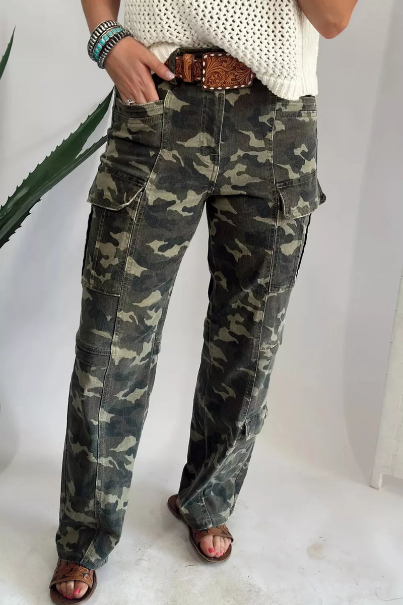 Person wearing camouflage pants on a white background