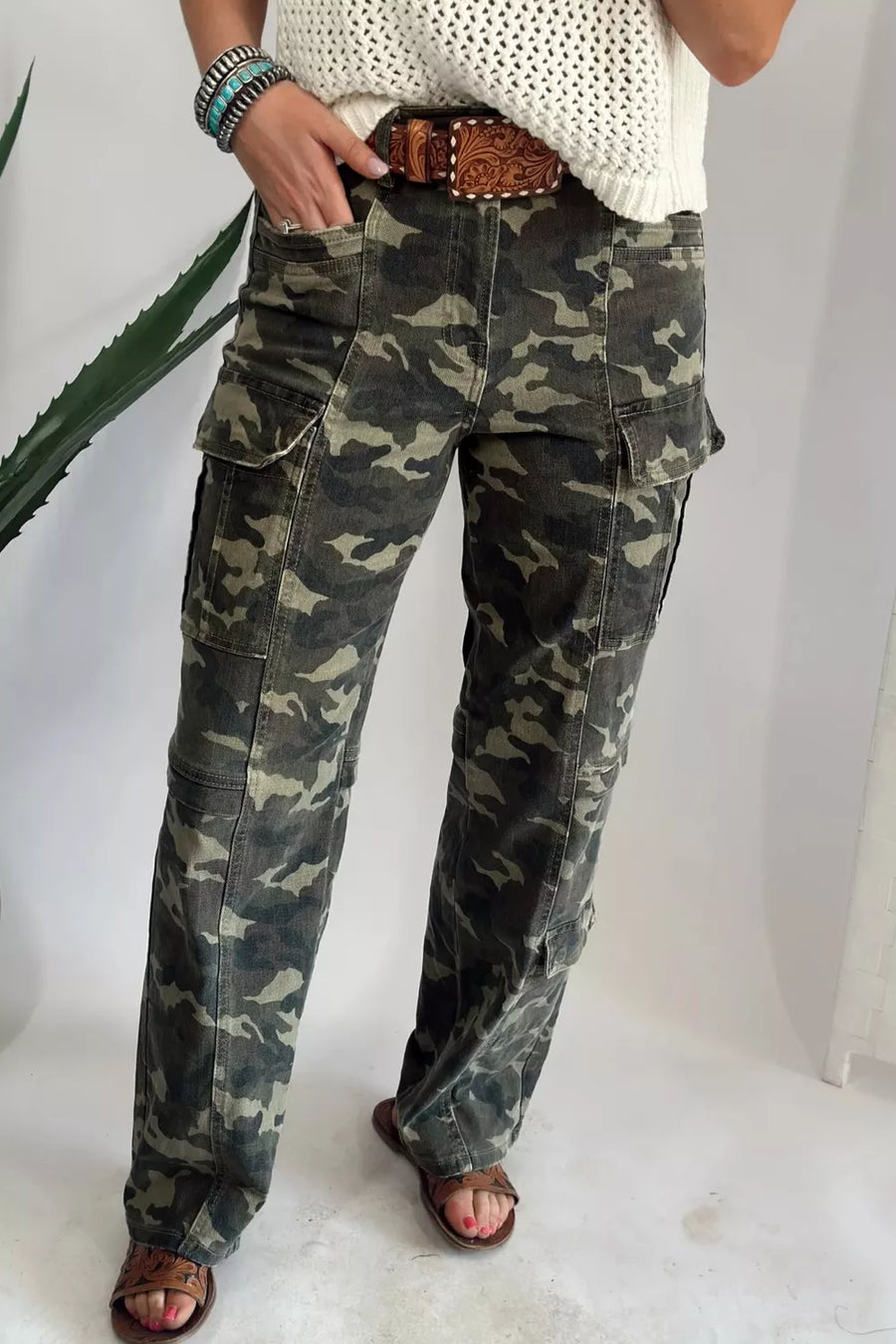 Person wearing camouflage pants on a white background