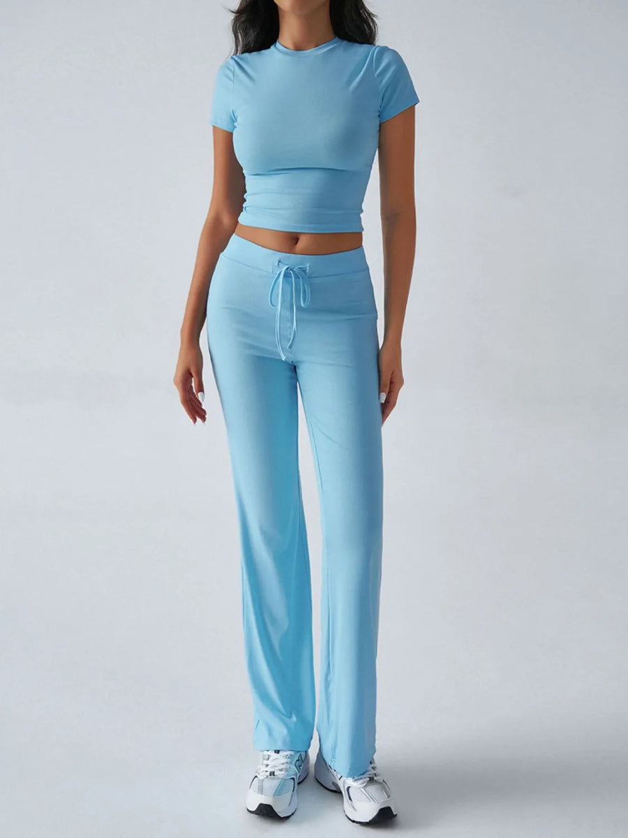 Person wearing a light blue athletic outfit on a white background