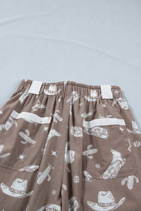 Brown pants with white graphic designs on a light gray background