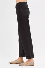 Black pants worn by a person on a white background