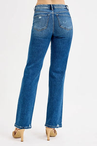 Blue jeans worn by a person on a white background