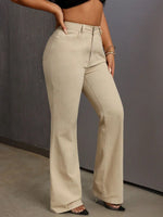 Person wearing beige wide-leg pants against a gray background