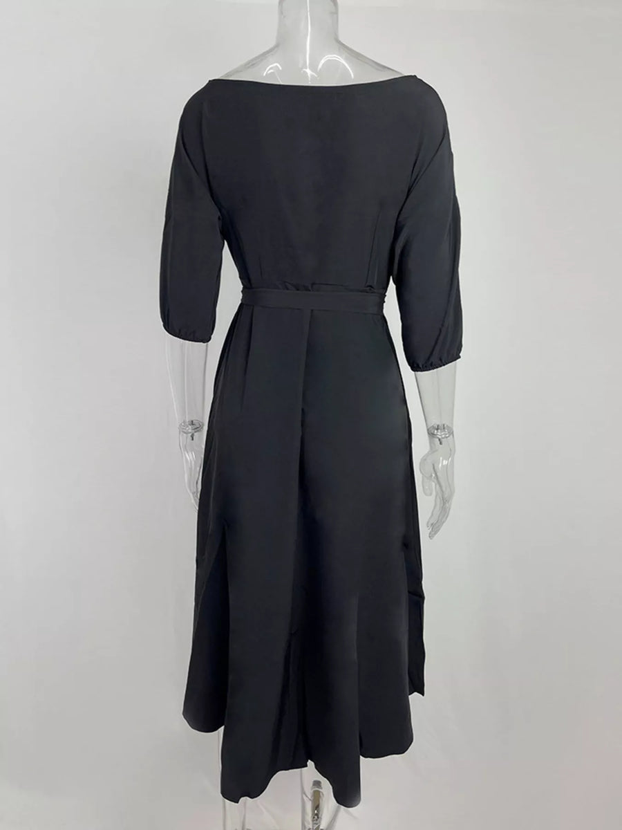 Black dress on a mannequin against a white background