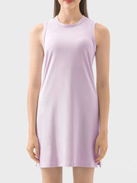 Woman wearing a light purple sleeveless dress on a white background