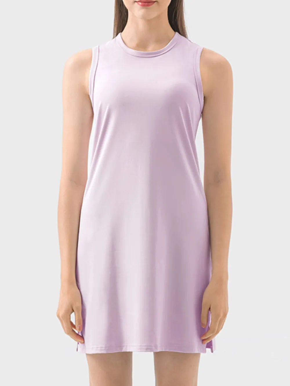 Woman wearing a light purple sleeveless dress on a white background