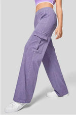 Person wearing purple cargo pants on a light gray background