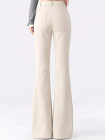 A person shown from the back wearing high-waisted, wide-leg cream pants with a gray long-sleeve top, photographed against a clean white studio background.